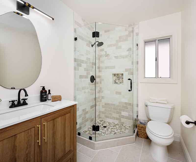 Modern bathroom remodel with glass shower enclosure, vanity, and toilet installation by L.F. Fenimore Plumbing and HVAC in South New Jersey.