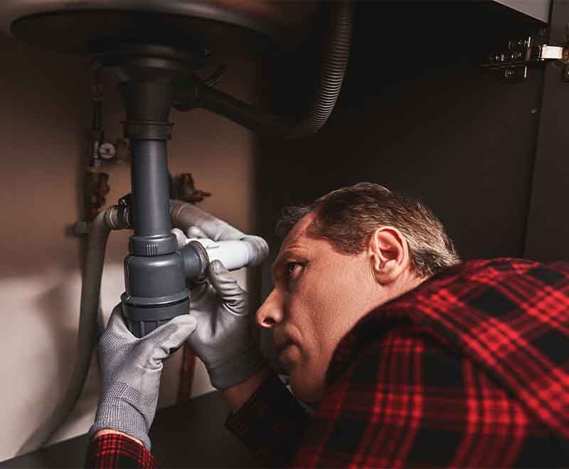 Professional plumber performing drain cleaning service in South Jersey.
